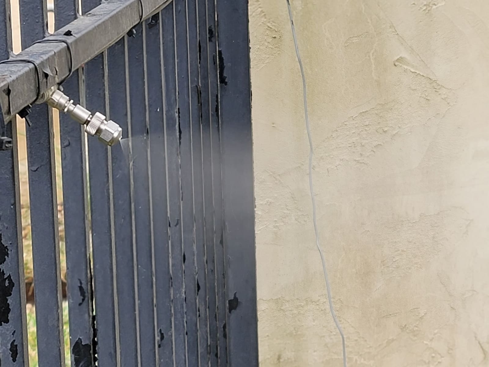 Exterior misting system components installed on a property