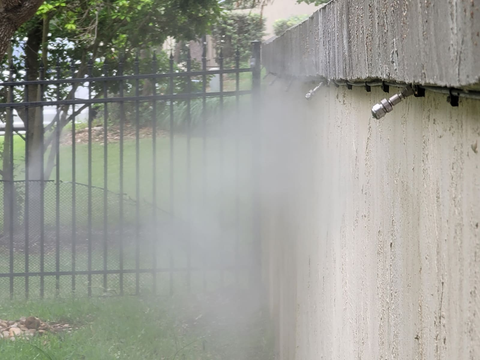 Close-up of a misting system nozzle and line
